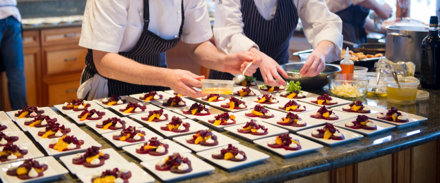 Chef's plating up a beet salad