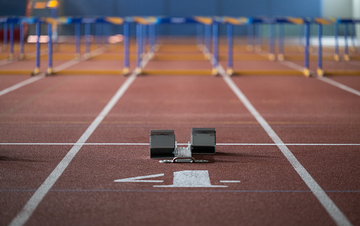 Starting blocks on track for running with hurdles. Sports and competition concept