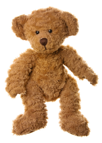 brown teddy bear lies wrapped in a white soft blanket, space for text
