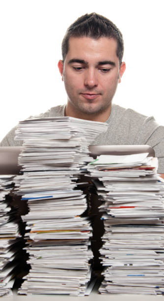 istock Financial Problems, Young Man with Paperwork Overload and Unpaid Bills 168629861