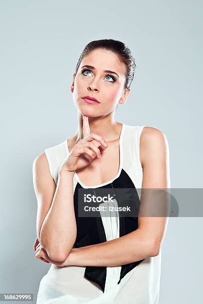 Thinking Young Woman Studio Portrait Stock Photo - Download Image Now - Women, One Woman Only, Contemplation