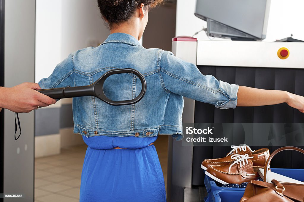 At the airport security check Teenaged girl is getting the metal detector wand at the airport security checkpoint. Airport Stock Photo