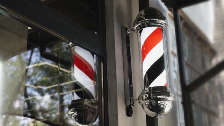 Close-up of a rotating barber shop pole. The barbershop logo rotates when entering the haircut studio.