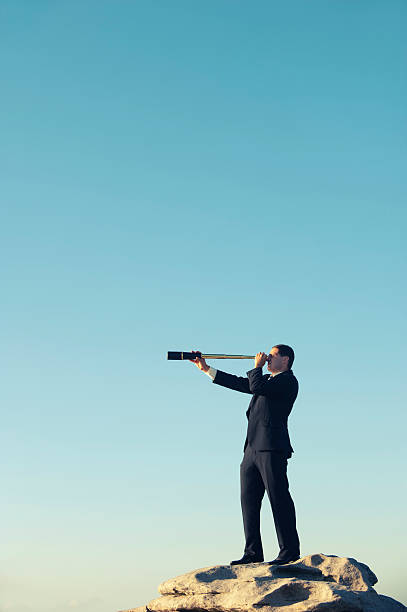 istock Businessman looking to the future with telescope 168631755