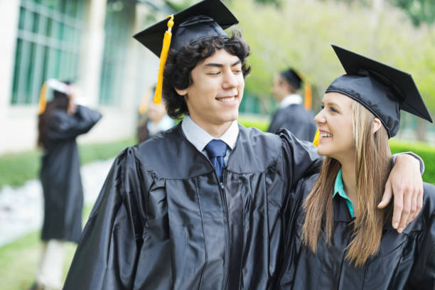 istock Happy graduates smiling with each other at graduation ceremony 168631818