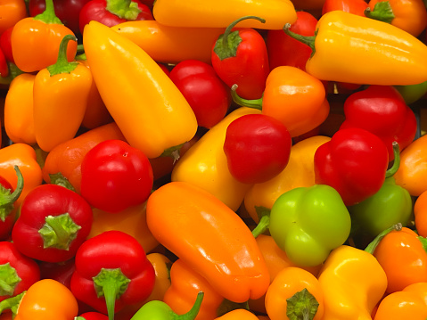 Red Yellow and Green Bell Peppers Vegetable Stall Display.