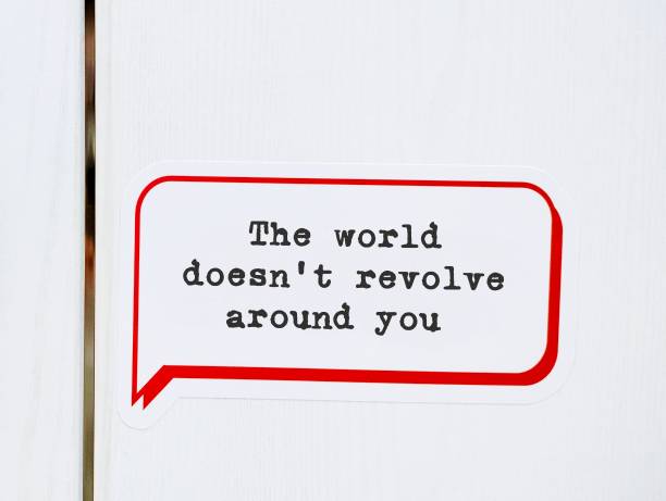 istock Speech sticker on wall background with message - The world doesnt revolve around you - to remind we are the center of the universe, not as important that much, stop taking everything personally 1686323736