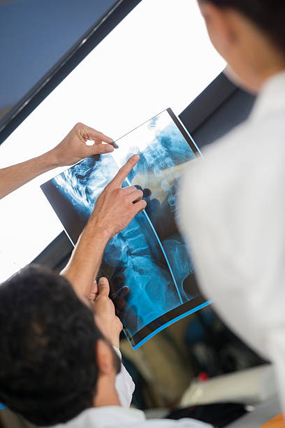 istock Doctor consulting with a surgeons on patient's MRI 168632476