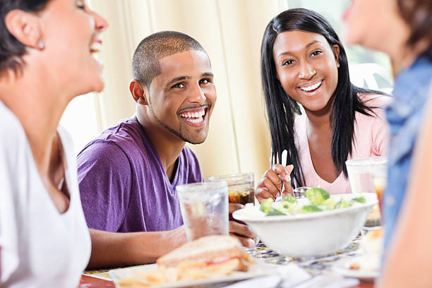 istock Young Woman Having Lunch With Friends At Restaurant. 168632941