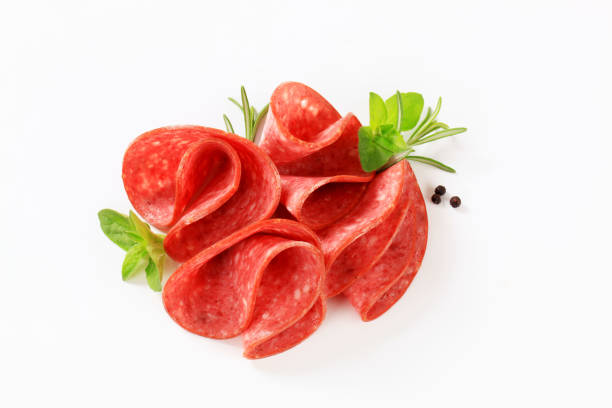 salami roses thin slices of a red salami with fresh basil, thyme and black pepper arranged like roses on a white background sliced salami stock pictures, royalty-free photos & images