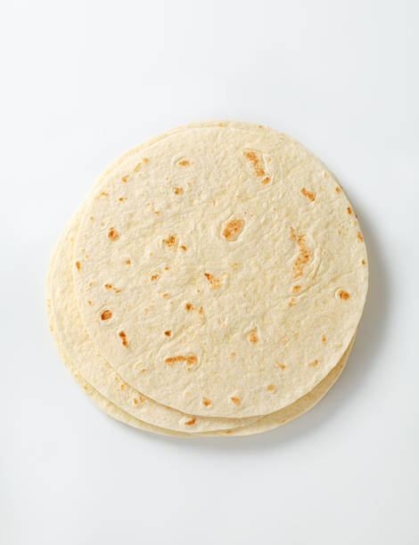 mexican tortillas stack of mexican tortillas on a white background tortilla flatbread stock pictures, royalty-free photos & images