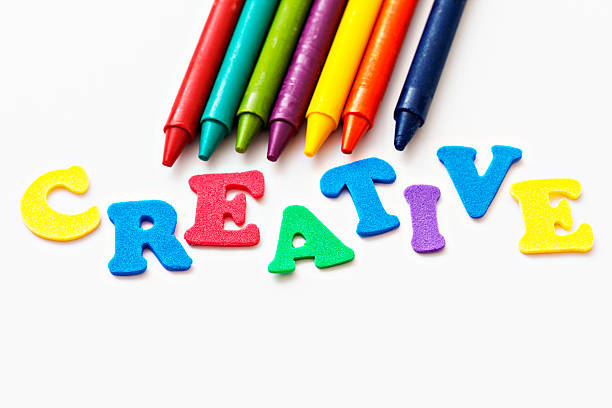 Play alphabet spells CREATIVE next to rainbow-colored crayons