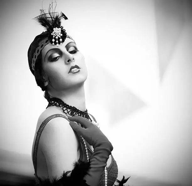 Black and White Portrait of The Beautiful Retro woman in Black Lace and Accessories  in Style 1920s - 1930s 