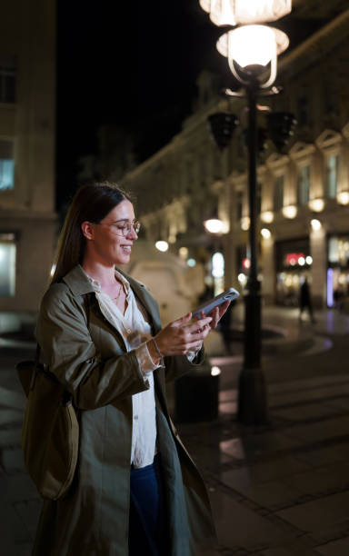 istock Woman Finds Solace in Mobile Phone on Nighttime Stroll 1686362915