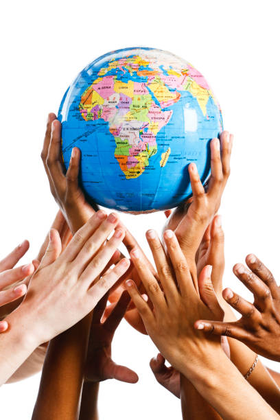 istock Many hands reach for a globe of the earth 168639182