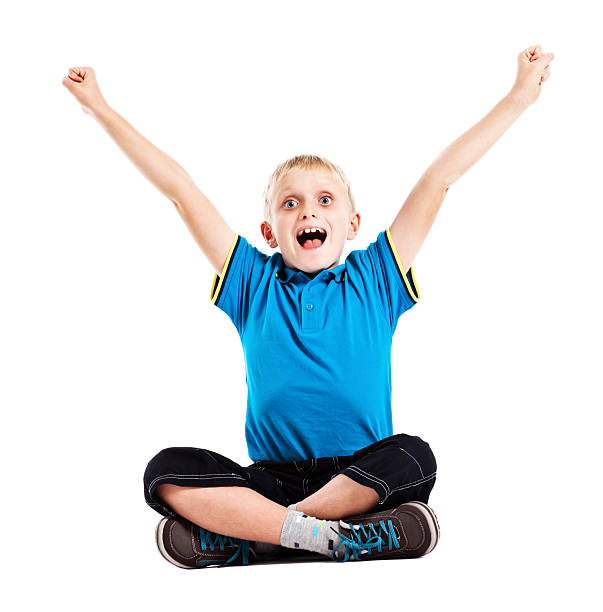 istock Delighted and elated little boy sitting cross legged 168639215