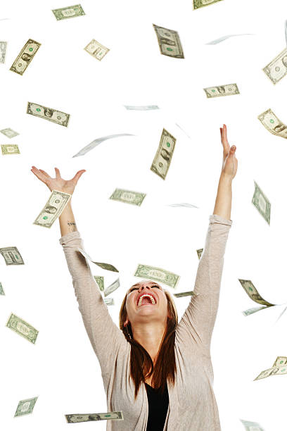 istock Overjoyed woman catching shower of falling banknotes 168640016