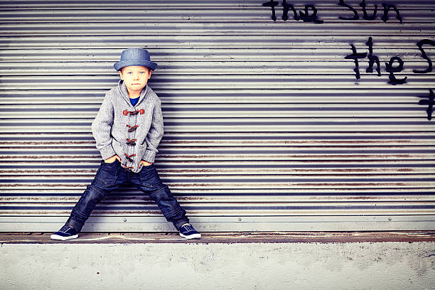 Little Boy on Loading Dock A cute, four year old little boy wearing a fedora style hat and sweater, standing on a grungy loading dock. Kids fashion, back to school concept. Similar images. cool graffiti characters stock pictures, royalty-free photos & images