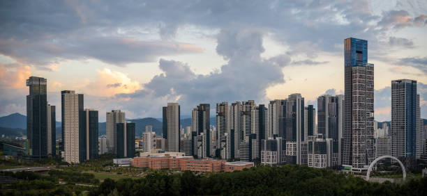 Sejong City Panoramic Skyline and tall buildings at sunset with dramatic clouds with warm glow over skyscrapers stock photo