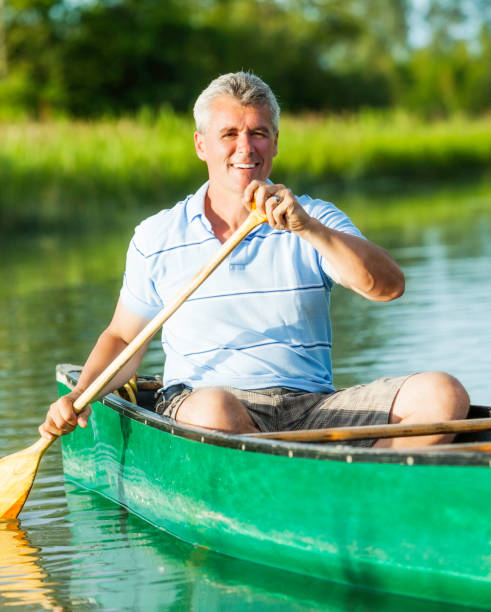 istock Mature Man Paddling a Canoe 168646451