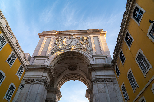 Spectacular Arco da Rua Augusta - Lisbon - Portugal. Richly ornamented triumphal arch, from the c. XVIII, with carved figures and views towards the city center.. Beautiful sunset colours