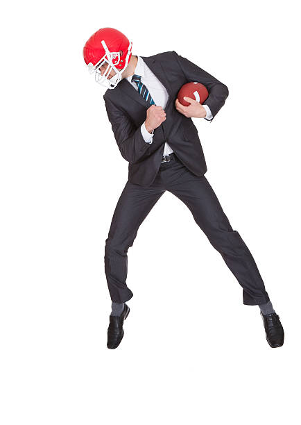 istock Competitive businessman playing american football 168649710