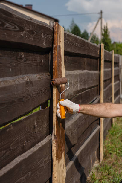 istock A man covers fence boards with an antiseptic 1686501619