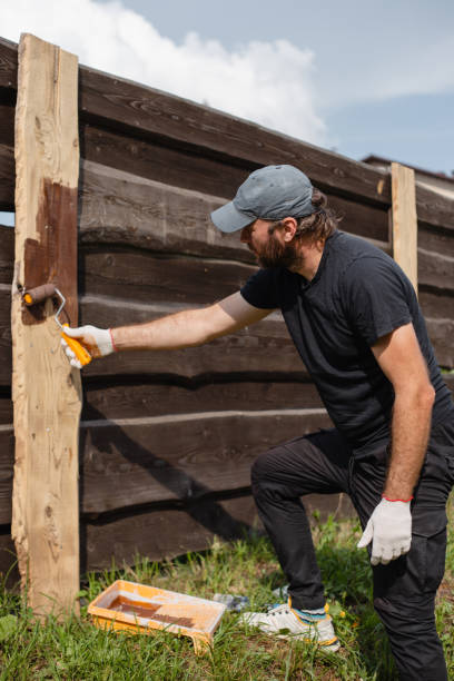 istock A man covers fence boards with an antiseptic 1686501620