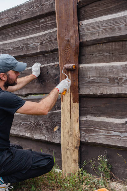 istock A man covers fence boards with an antiseptic 1686502138