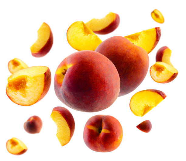 istock Superbly retouched whole peaches and slices fly and levitate in space. Selective focus. Isolated on white 1686502677