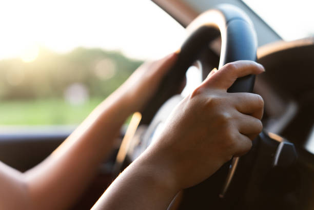 istock driving car with her hand on the wheel 1686503724