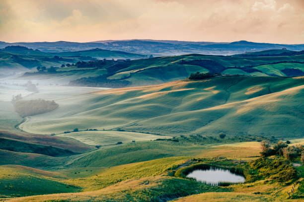Beautiful view of tuscany at sunset with Siena in the background, Crete Senesi, Siena Province, Italy Beautiful view of tuscany at sunset with Siena in the background, Crete Senesi, Siena Province, Italy crete senesi stock pictures, royalty-free photos & images