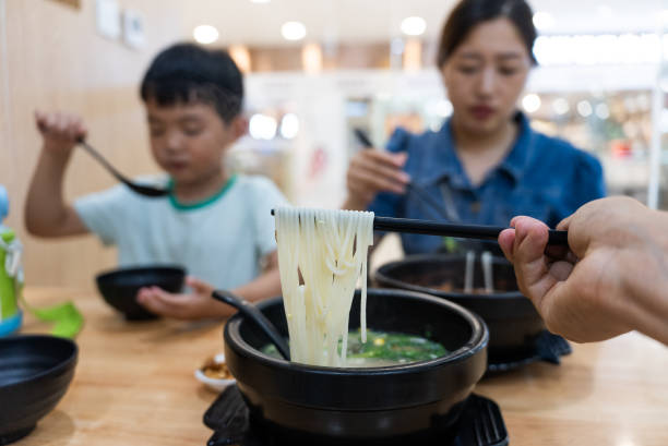 Eating rice noodles in restaurant