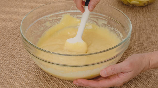 istock Apple cake with biscuit base recipe, step by step baking process.  Biscuit daugh in a glass bowl. Ingredients close up on kitchen table 1686518503