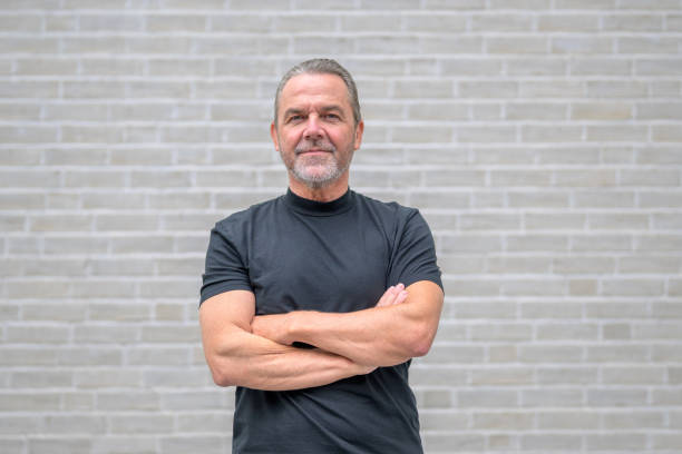 istock Front view of a man with crossed arms looking in a friendly and determined manner 1686529240