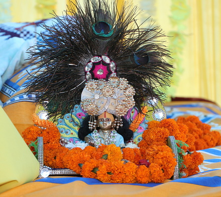 Idol of Hindu god Lord Krishna decorated at home on the occasion of Bhagwat Katha.