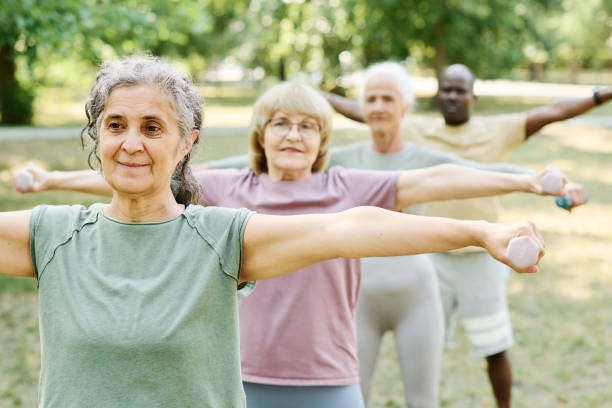 istock Senior people exercising with dumbbells outdoors 1686540302