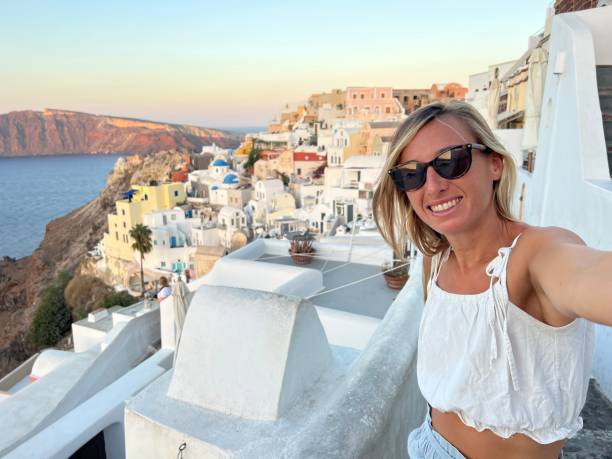 istock Tourist takes selfie in Santorini at sunset 1686558411