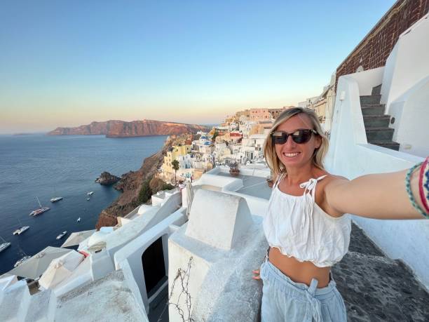 istock Tourist takes selfie in Santorini at sunset 1686559590