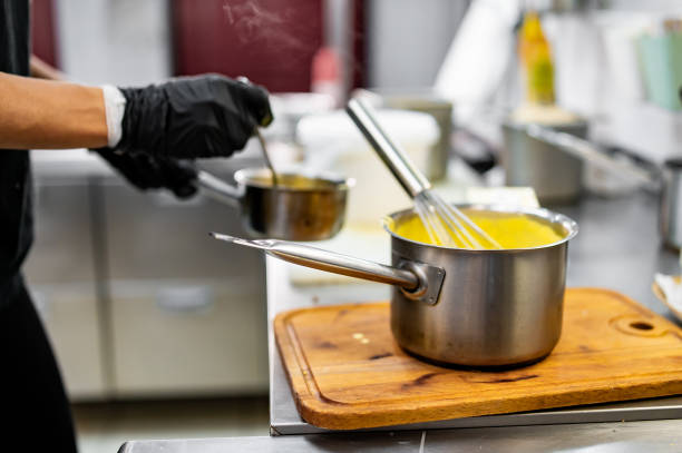 istock Chef hands cooking cheese sauce in the restaurant kitchen 1686579692
