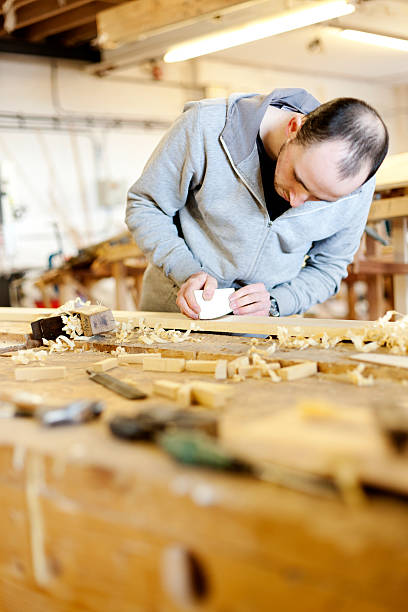 istock Boat carpenter with a wood plane 168658155