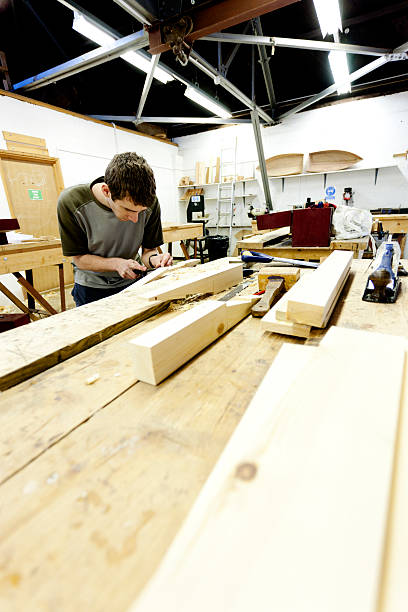 istock Boat builder shaping a piece of wood 168658159
