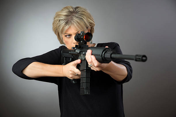 woman in jeans suit with the shooting range shot from a rifle gun,girl and gun with isolated on background,hunting sport equipment