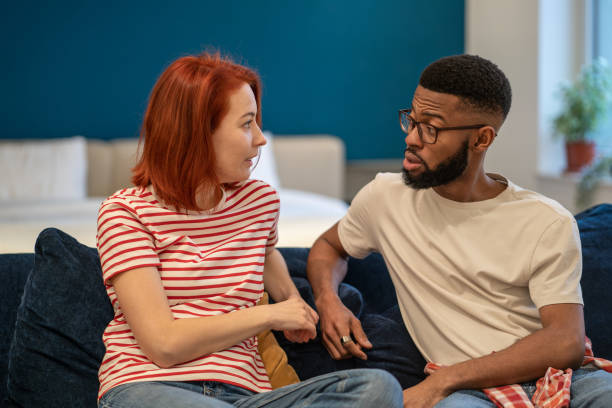 istock Young interracial couple husband and wife sit on bed at home discussing intimacy issues 1686605872