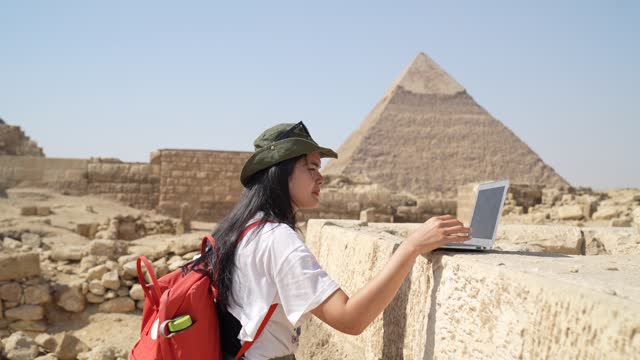 asian archaeologist female working an research the pyramid pharaoh in Giza Cairo