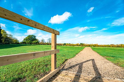 Peaceful rural scene of a wooden fence in park