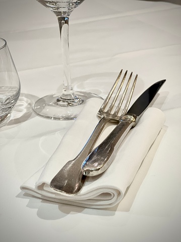 cutlery on a napkin on a table in a restaurant