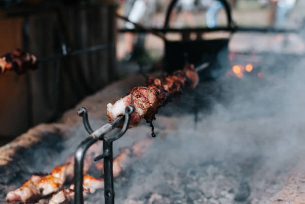 istock Roasting meat on a spit, close-up, selective focus 1686630040