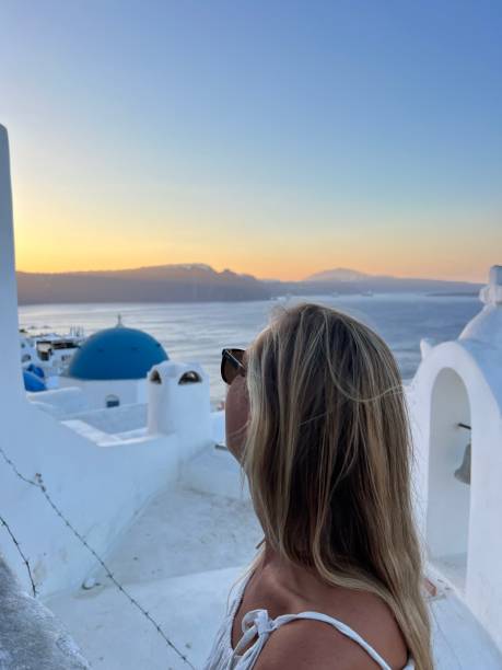 istock Female contemplates Santorini from top, Greece 1686639065