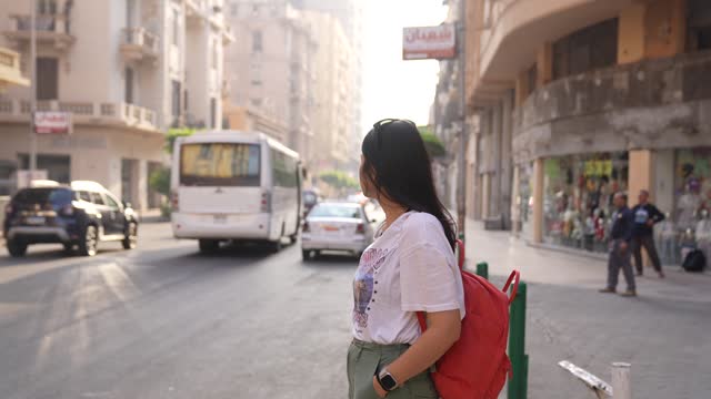 beautiful young lady waiting for taxi or bus in Cairo city
